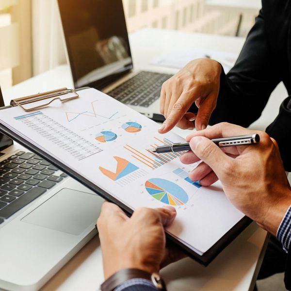 workplace-results-professional-report-accounting-during Business concept. Business people discussing the charts and graphs showing the results of their successful teamwork. Selective focus.